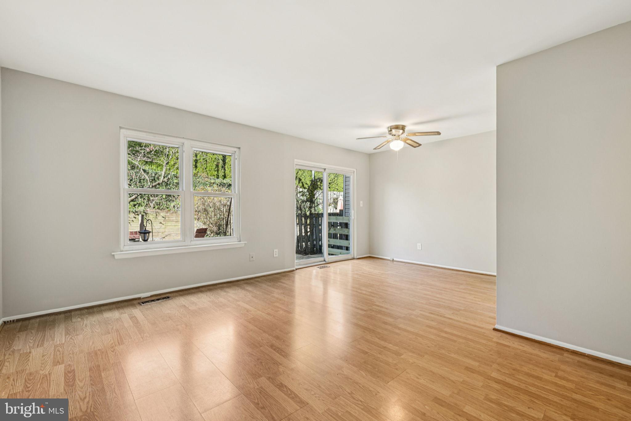19924 Wyman Way Germantown, MD 20874 - Photo 14 of 47 a view of an empty room with wooden floor and a window