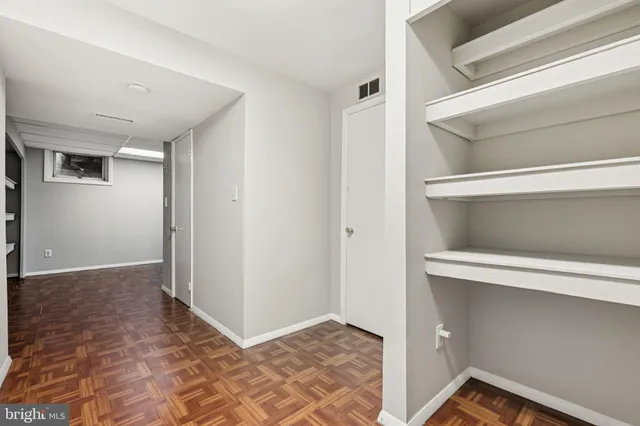 a view of an empty room with a closet