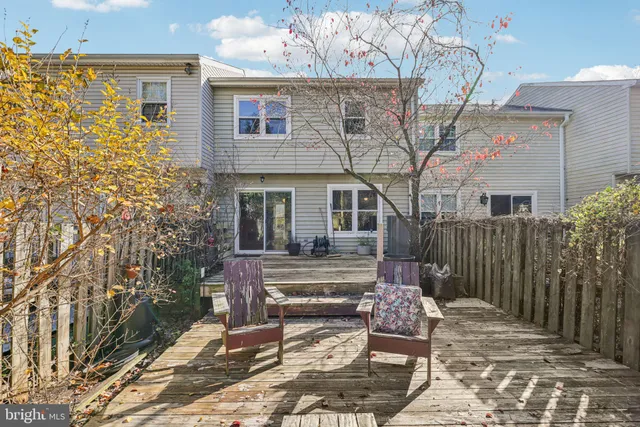 a backyard of a house with barbeque oven table and chairs