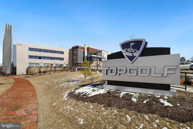 a view of a building with car parked