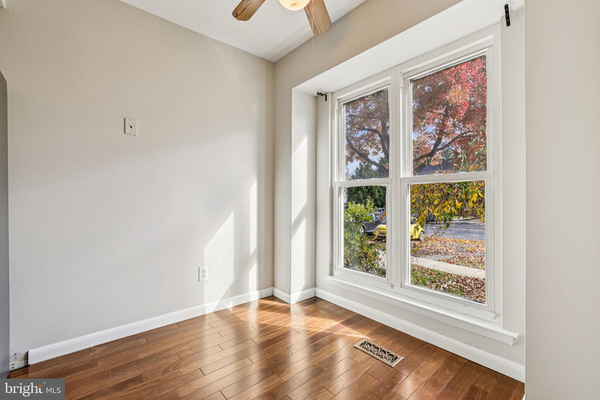 19924 Wyman Way Germantown, MD 20874 - Photo 6 of 47 an empty room with wooden floor and windows