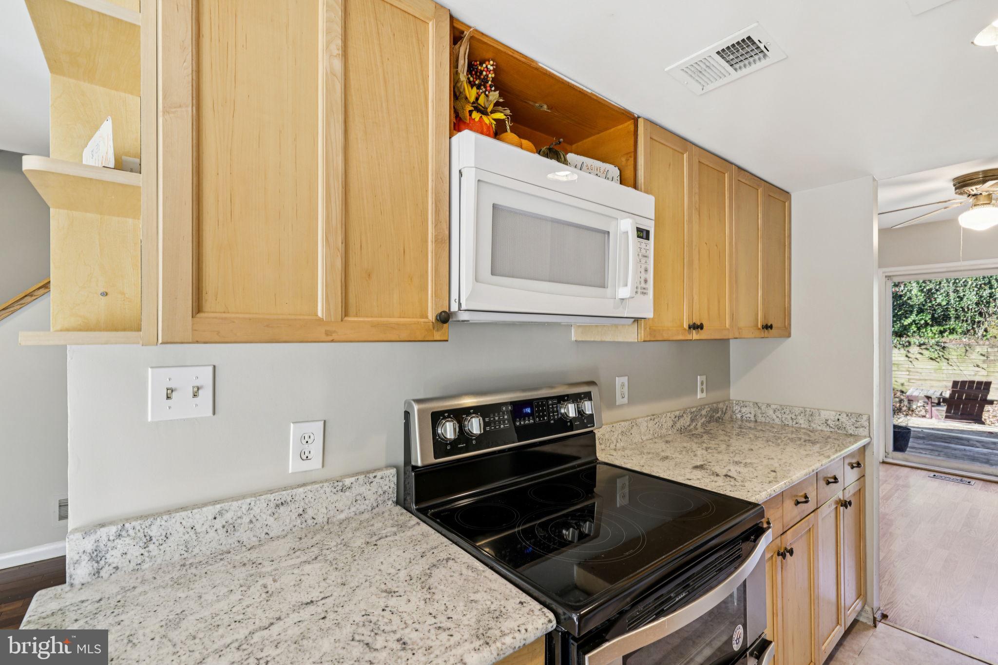 19924 Wyman Way Germantown, MD 20874 - Photo 8 of 47 a kitchen with stainless steel appliances granite countertop a stove and a microwave