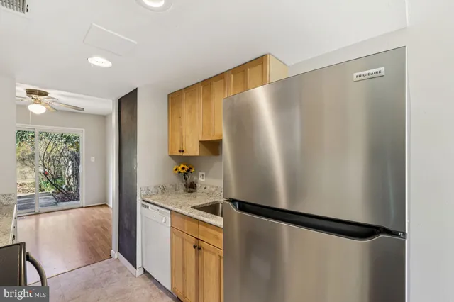 a kitchen with stainless steel appliances a refrigerator and a dresser
