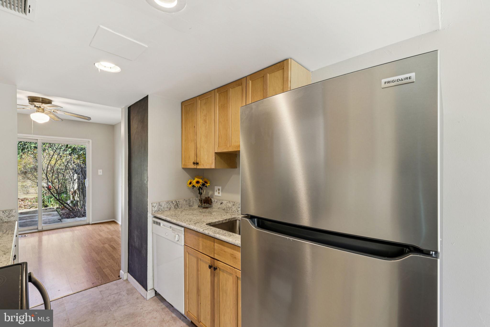 19924 Wyman Way Germantown, MD 20874 - Photo 9 of 47 a kitchen with stainless steel appliances a refrigerator and a dresser
