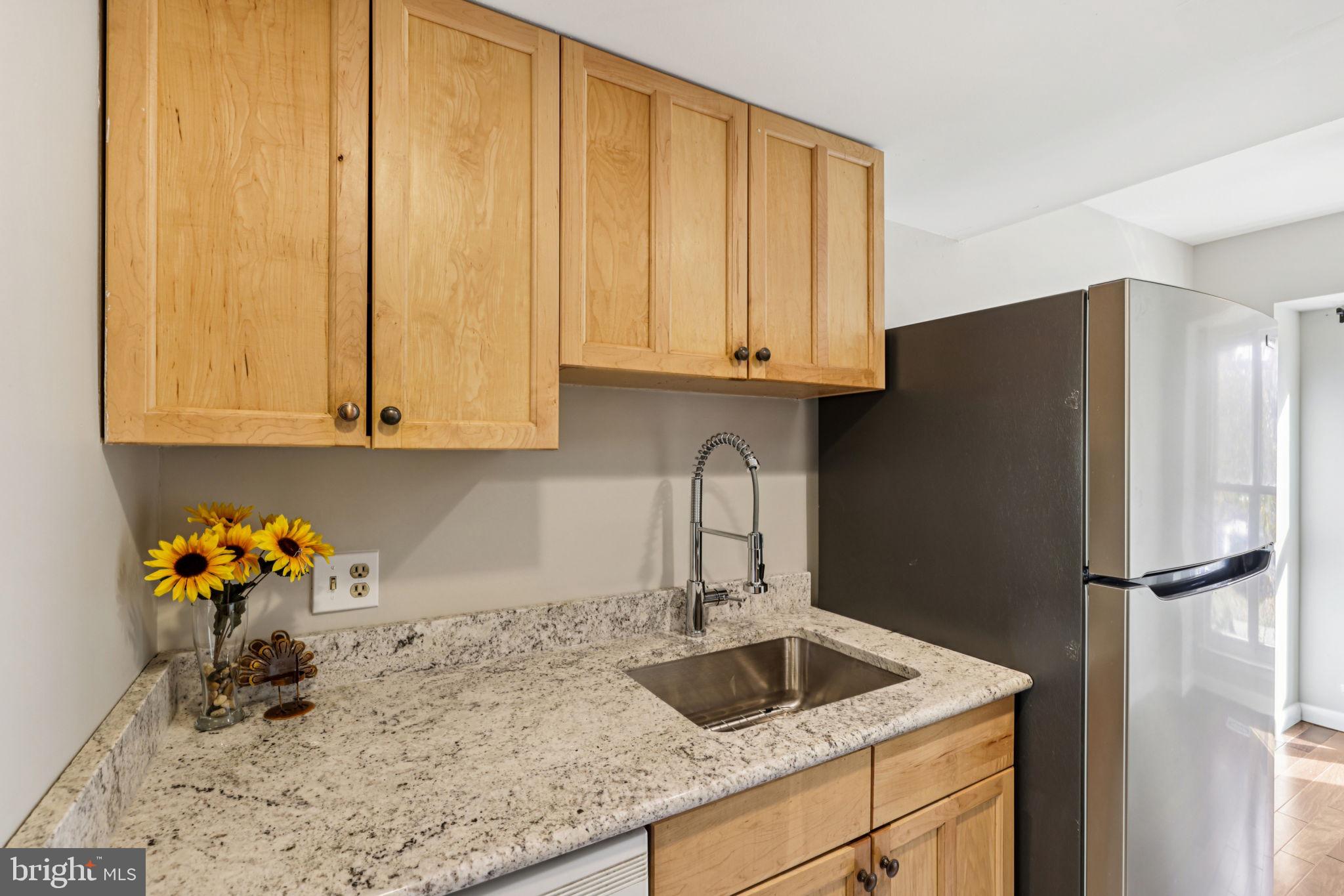 19924 Wyman Way Germantown, MD 20874 - Photo 10 of 47 a kitchen with stainless steel appliances granite countertop a refrigerator sink and cabinets