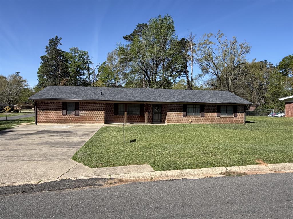 118 Carolyn Street Mansfield, LA 71052 - Photo 1 of 26 a front view of a house with a yard
