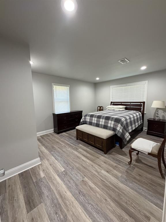 118 Carolyn Street Mansfield, LA 71052 - Photo 23 of 26 a bedroom with a bed and wooden floor