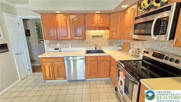 a kitchen with stainless steel appliances a stove sink and microwave