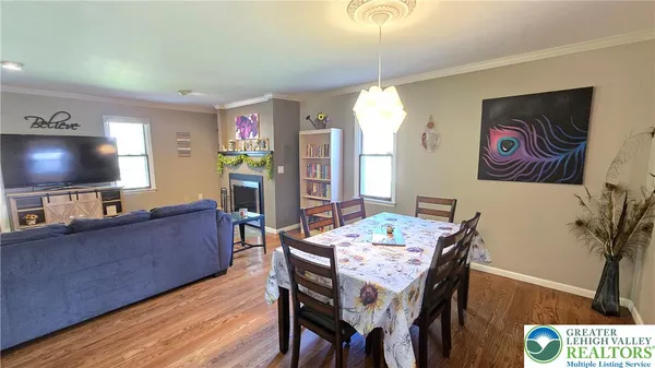 a view of a dining room with furniture kitchen and wooden floor