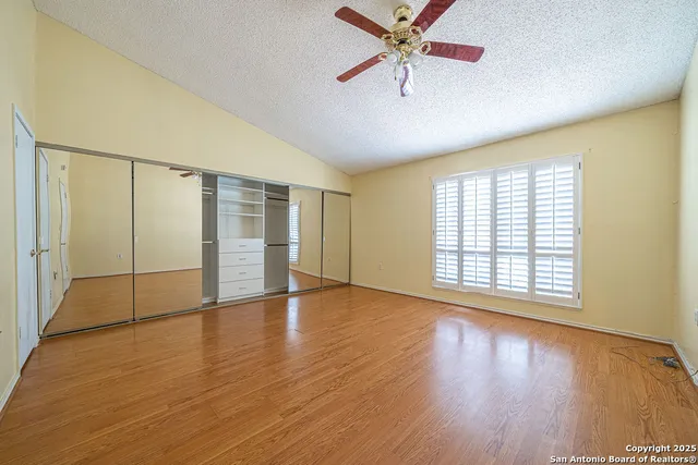 a view of an empty room with wooden floor
