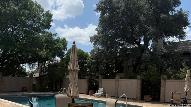 a view of a backyard with couches and a table