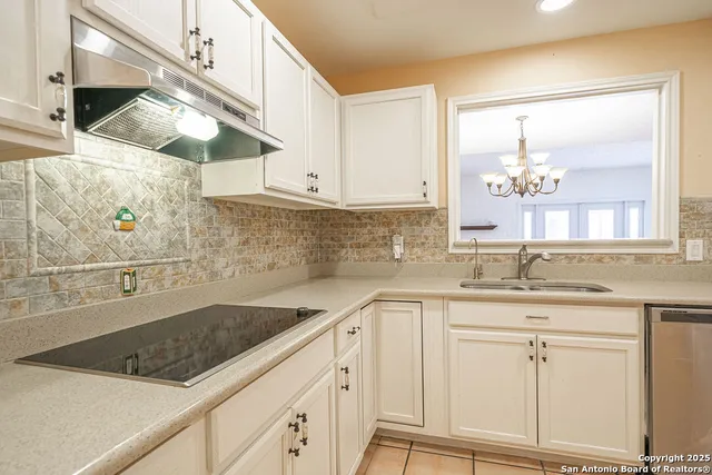 a kitchen with a sink and cabinets