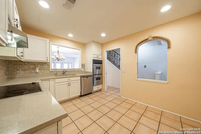a view of a closet area with wooden floor