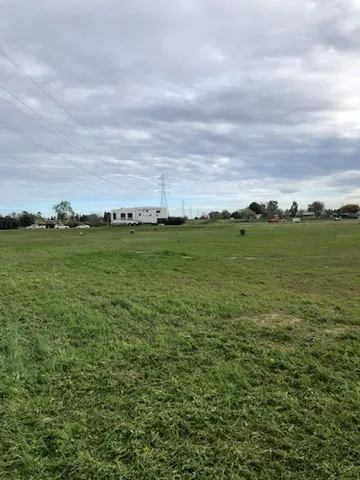 a view of a field with an ocean