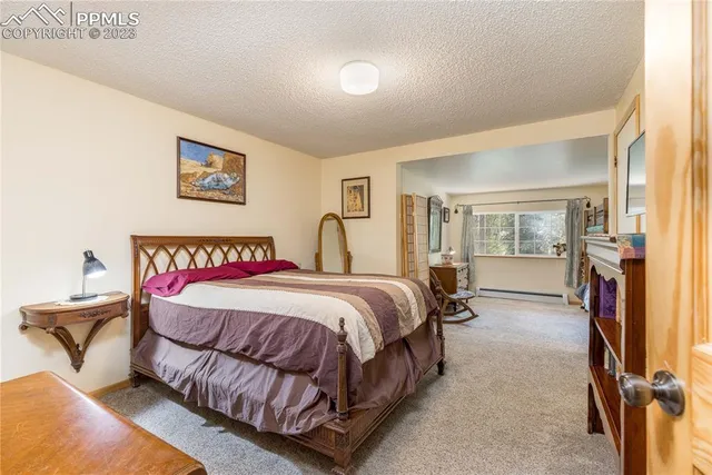 a spacious bedroom with a bed and large mirror