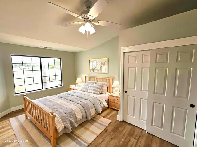 a bedroom with a bed and a window