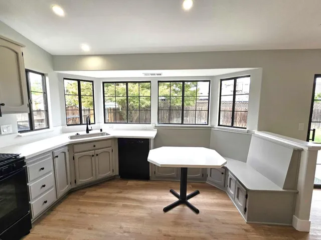 a spacious bathroom with a granite countertop sink and a large mirror
