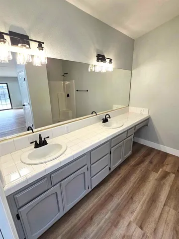 a bathroom with a double vanity sink and mirror