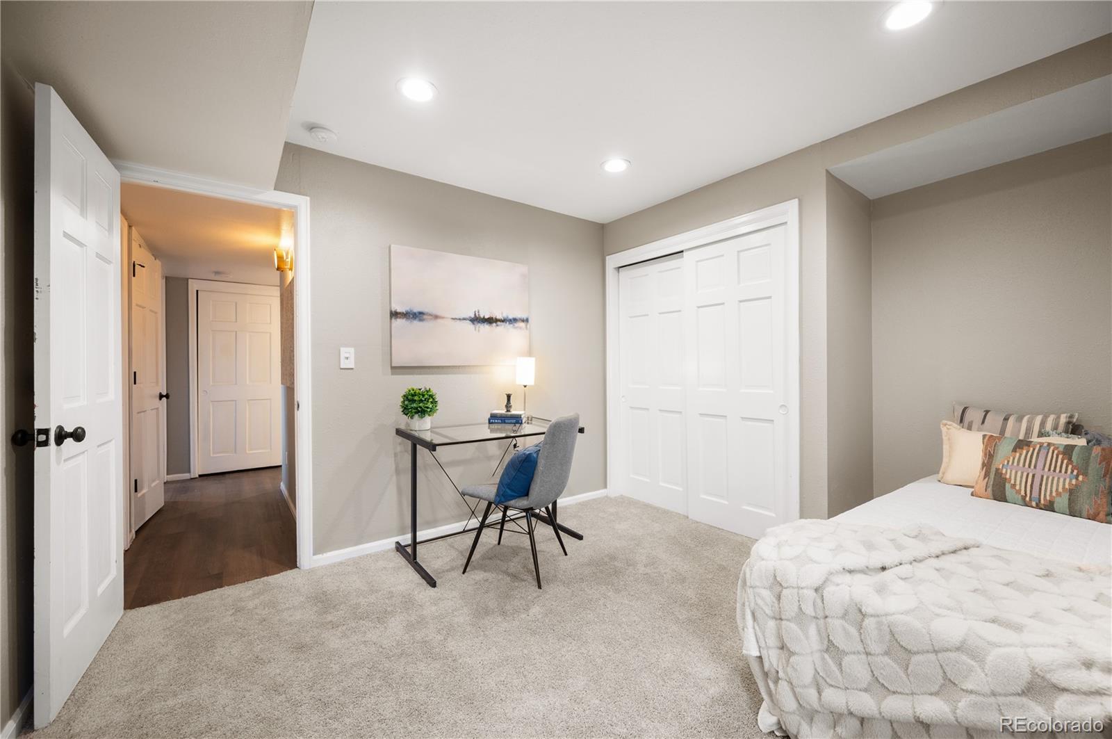 11740 Baca Road Conifer, CO 80433 - Photo 19 of 49 a bedroom with a bed a desk and chair