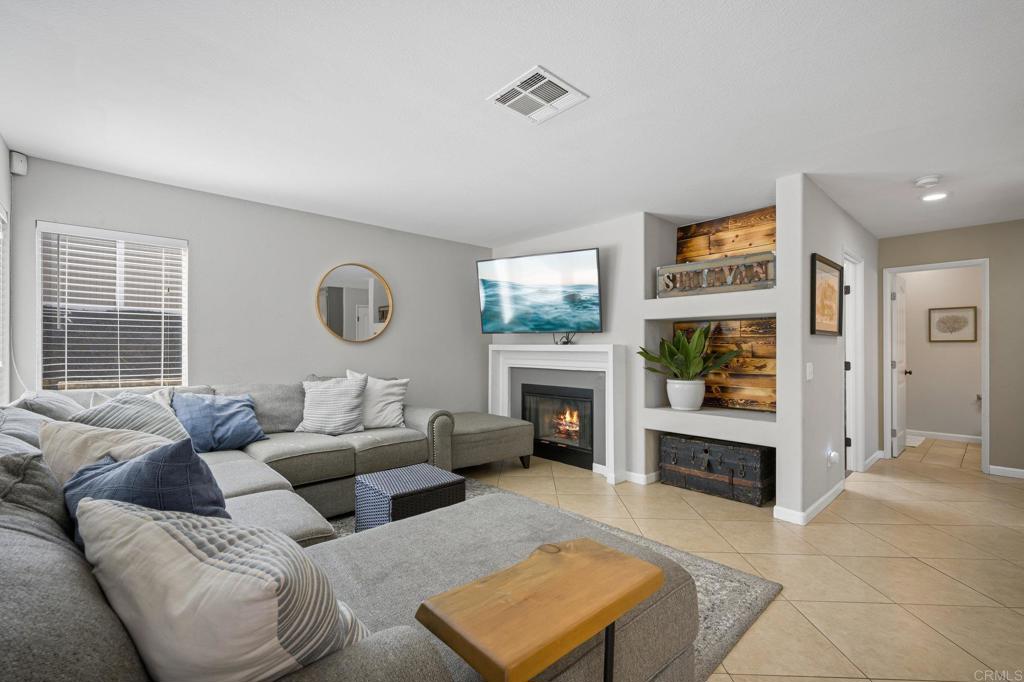13675 Stonybrook Lane El Cajon, CA 92021 - Photo 11 of 34 a living room with furniture windows and a fireplace