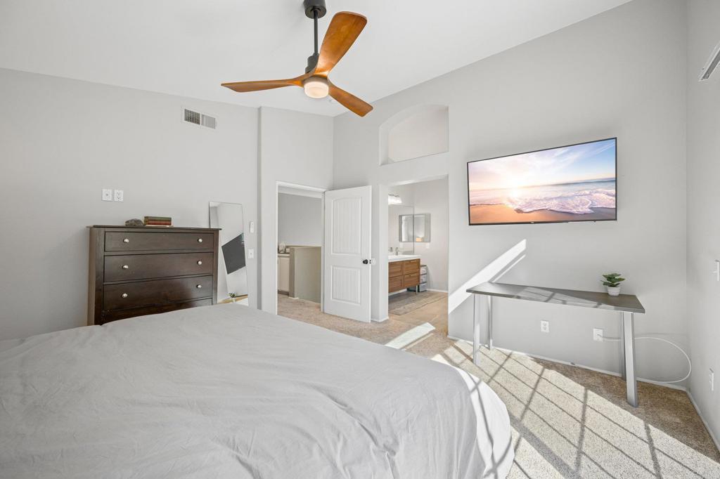 13675 Stonybrook Lane El Cajon, CA 92021 - Photo 19 of 34 a bedroom with a bed and a chandelier