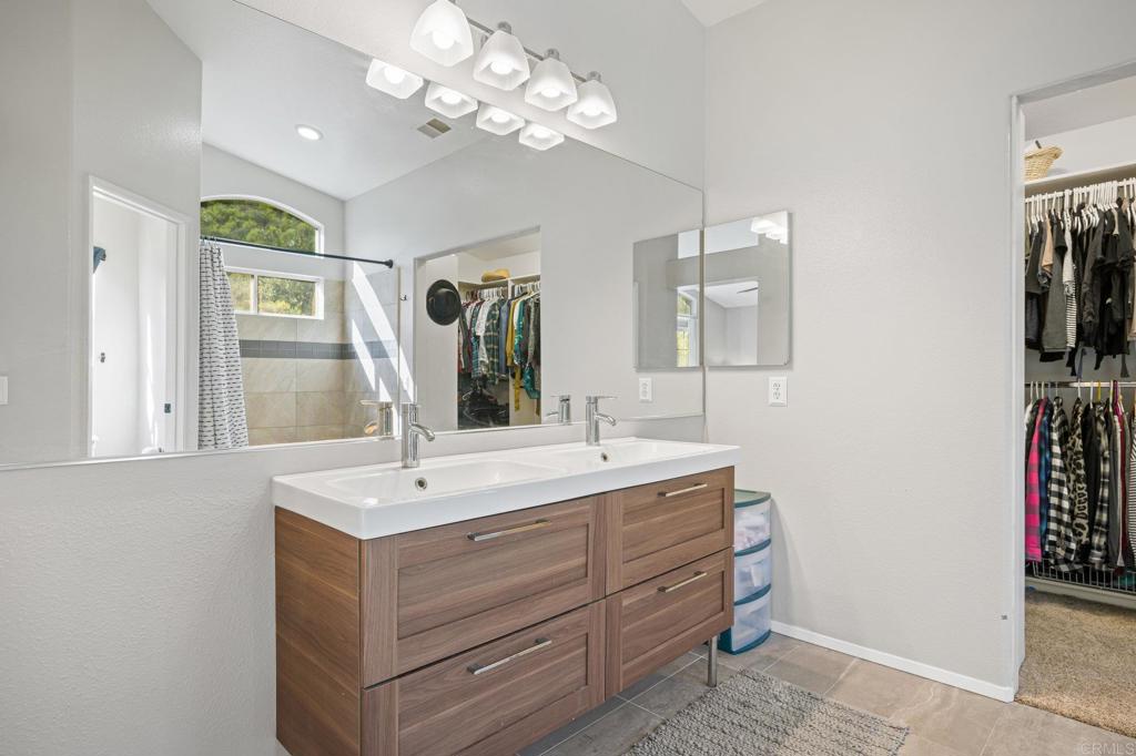 13675 Stonybrook Lane El Cajon, CA 92021 - Photo 20 of 34 a room with a sink vanity and mirror