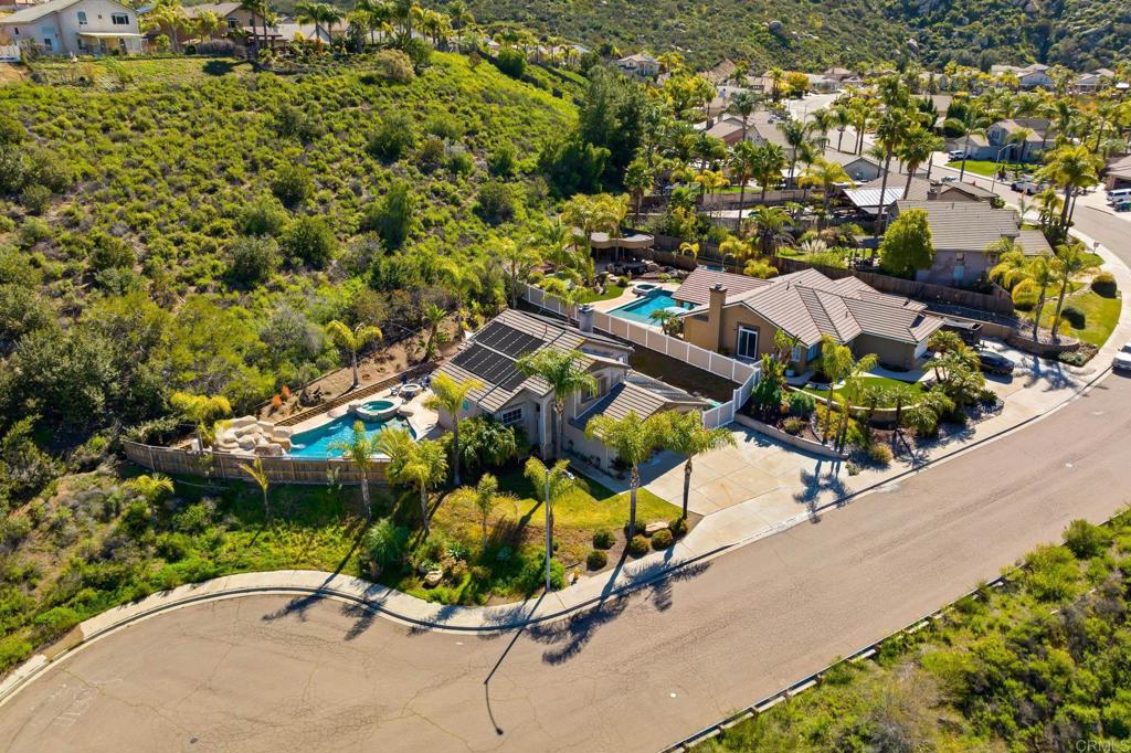 13675 Stonybrook Lane El Cajon, CA 92021 - Photo 26 of 34 an aerial view of a house with a yard and parking spaces
