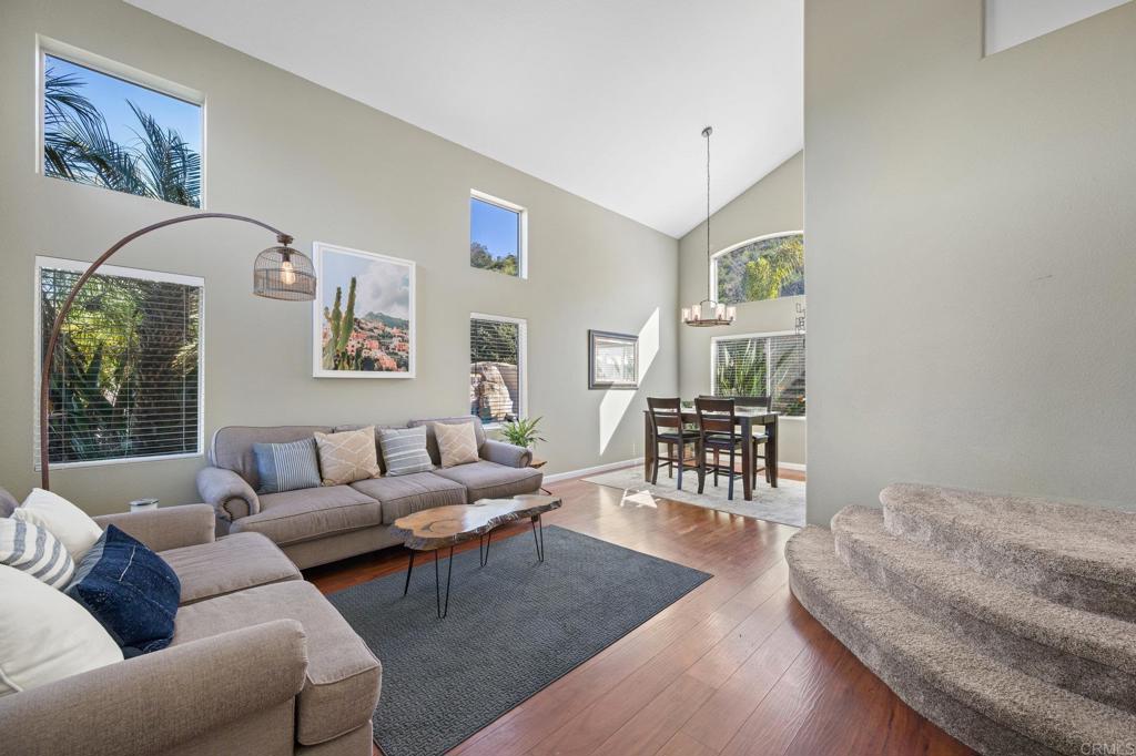 13675 Stonybrook Lane El Cajon, CA 92021 - Photo 4 of 34 a living room with furniture and a dining table with wooden floor