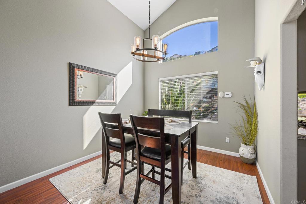 13675 Stonybrook Lane El Cajon, CA 92021 - Photo 5 of 34 a view of a dining room with furniture window and wooden floor