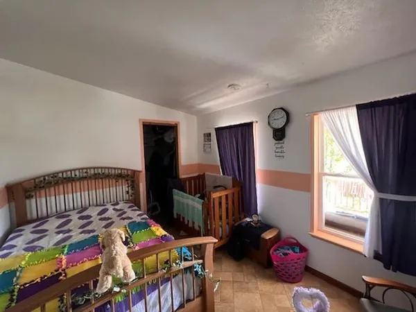 a bedroom with furniture and a window