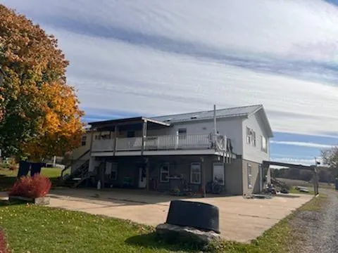 a view of a house with a patio and a yard