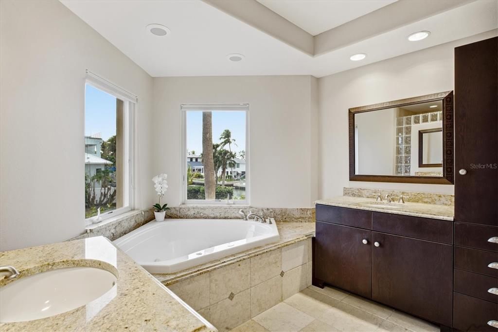 761 Norton Street Longboat Key, FL 34228 - Photo 26 of 66 a bathroom with a granite countertop tub sink and mirror