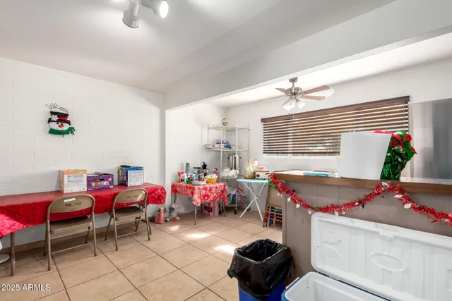 a front view of a house with a yard and an tree