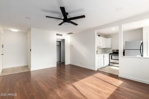 a view of a kitchen with wooden floor and a sink