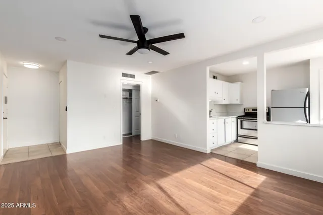 a view of a kitchen with wooden floor and a sink
