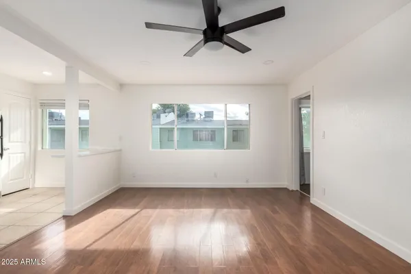 wooden floor in an empty room with a window