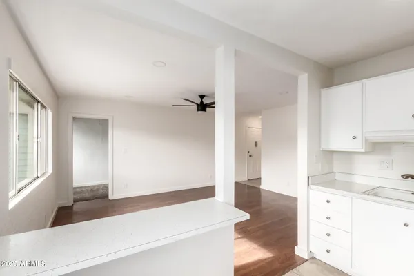 a kitchen with granite countertop a refrigerator and a stove top oven