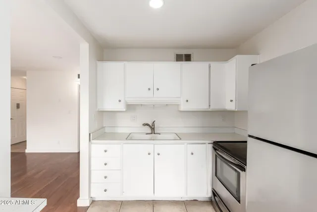 a view of small space with wooden floor and windows
