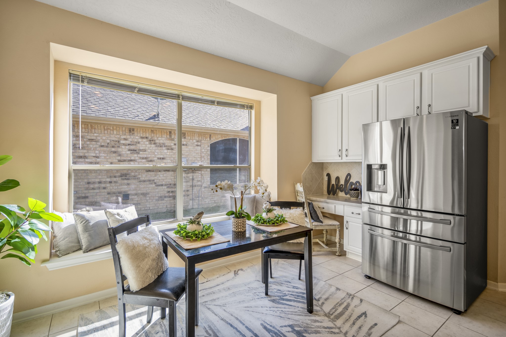 21107 Coldde Meadow Lane Spring, TX 77379 - Photo 15 of 50 A closer look at the breakfast area highlights the built-in bench and window seat, where natural light pours in through the surrounding windows. Positioned beside the kitchen, this space offers an easy place to start the day, enjoy a quick meal, or pause with a cup of coffee while looking out toward the backyard.