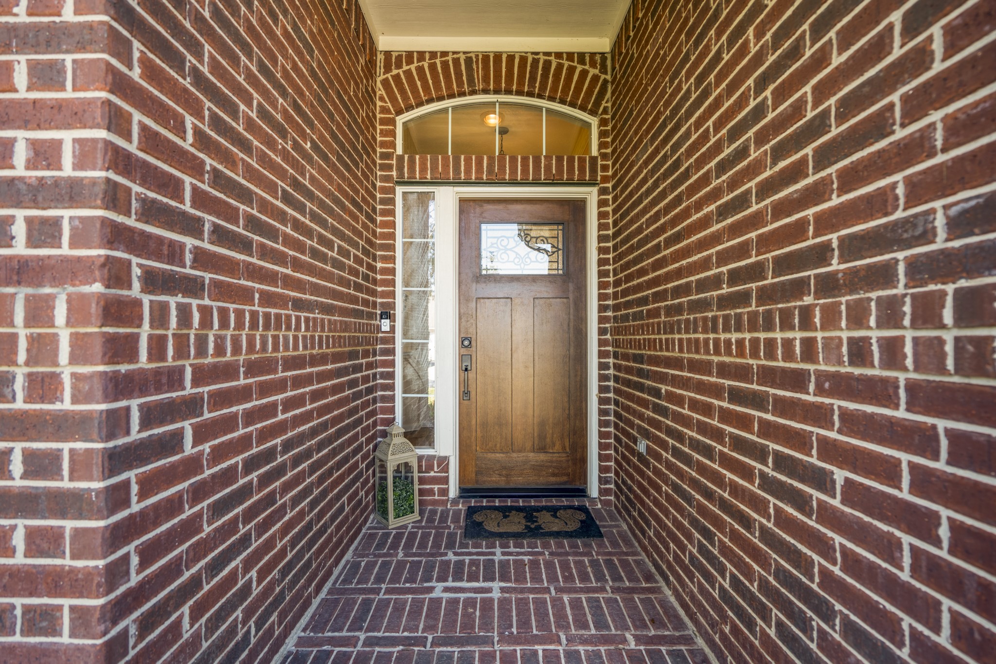 21107 Coldde Meadow Lane Spring, TX 77379 - Photo 2 of 50 A covered brick entry creates a welcoming approach to the front door, offering a bit of shade and shelter as you arrive. Glass panels at the door bring natural light inside and hint at the bright, comfortable spaces waiting just beyond.
