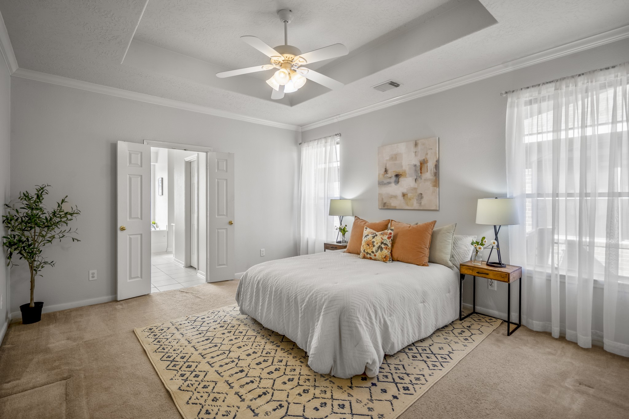 21107 Coldde Meadow Lane Spring, TX 77379 - Photo 23 of 50 a bedroom with a large bed and a chandelier