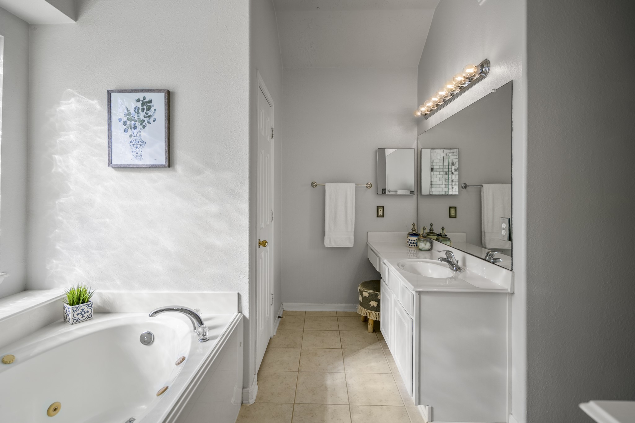 21107 Coldde Meadow Lane Spring, TX 77379 - Photo 26 of 50 a bathroom with a sink a bathtub and a window