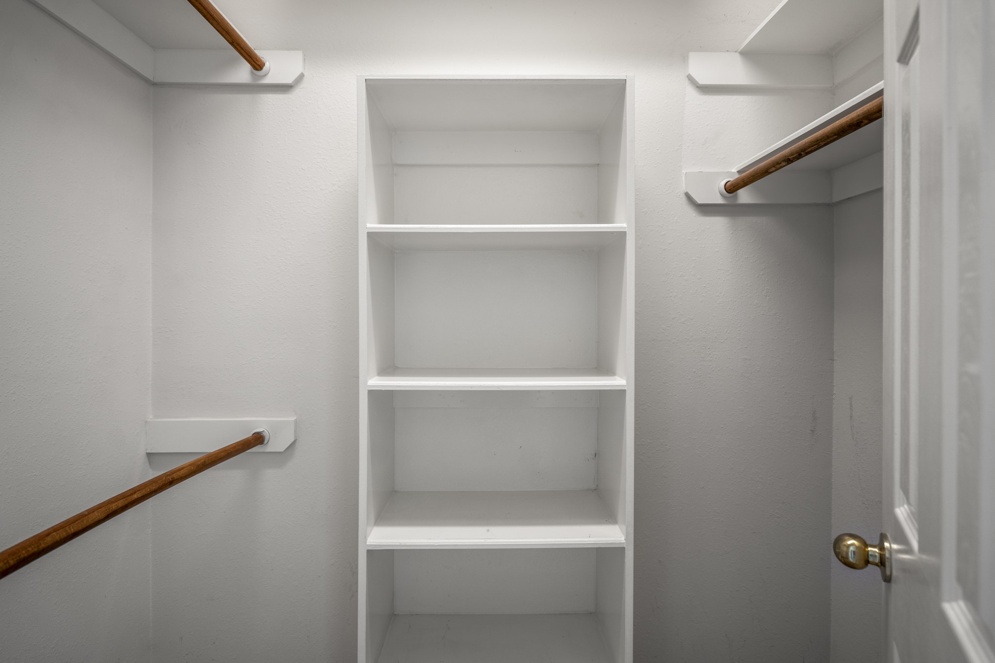 21107 Coldde Meadow Lane Spring, TX 77379 - Photo 27 of 50 One of two walk-in closets in the primary suite, positioned along the hallway between the bedroom and bathroom. Built-in shelving and hanging space provide organized storage while keeping everything easily accessible within the suite.