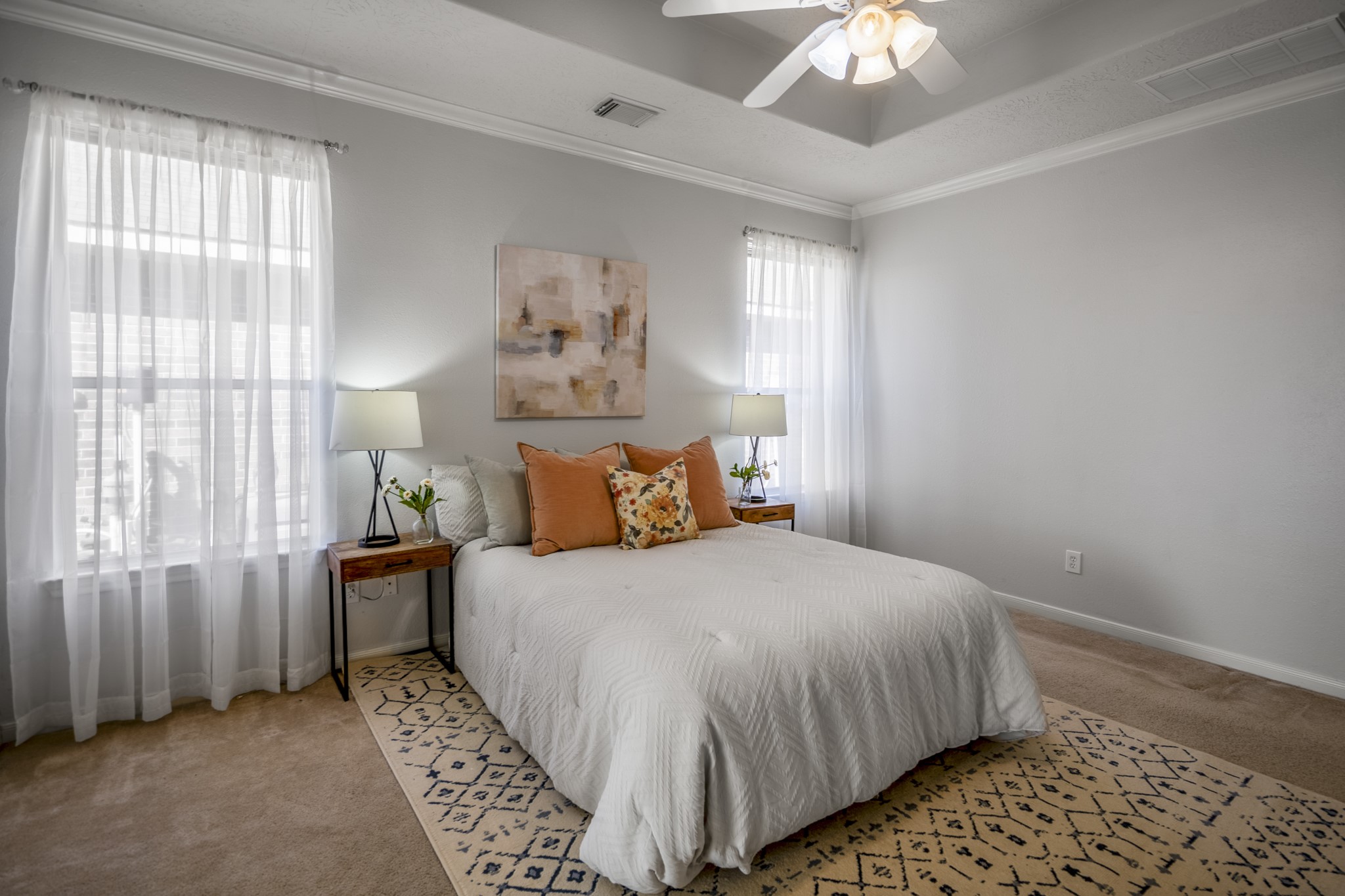 21107 Coldde Meadow Lane Spring, TX 77379 - Photo 29 of 50 a bedroom with a large bed and a chandelier