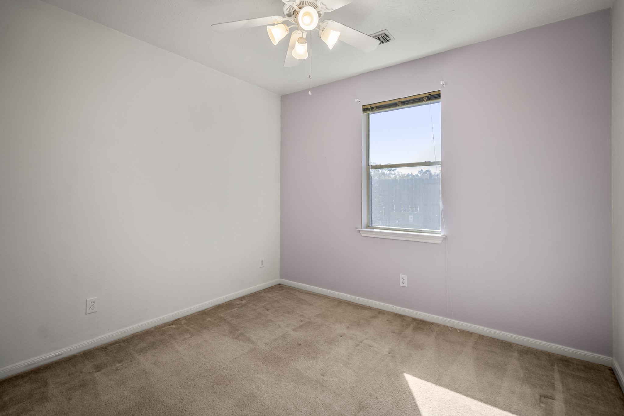 21107 Coldde Meadow Lane Spring, TX 77379 - Photo 30 of 50 an empty room with a chandelier fan and windows
