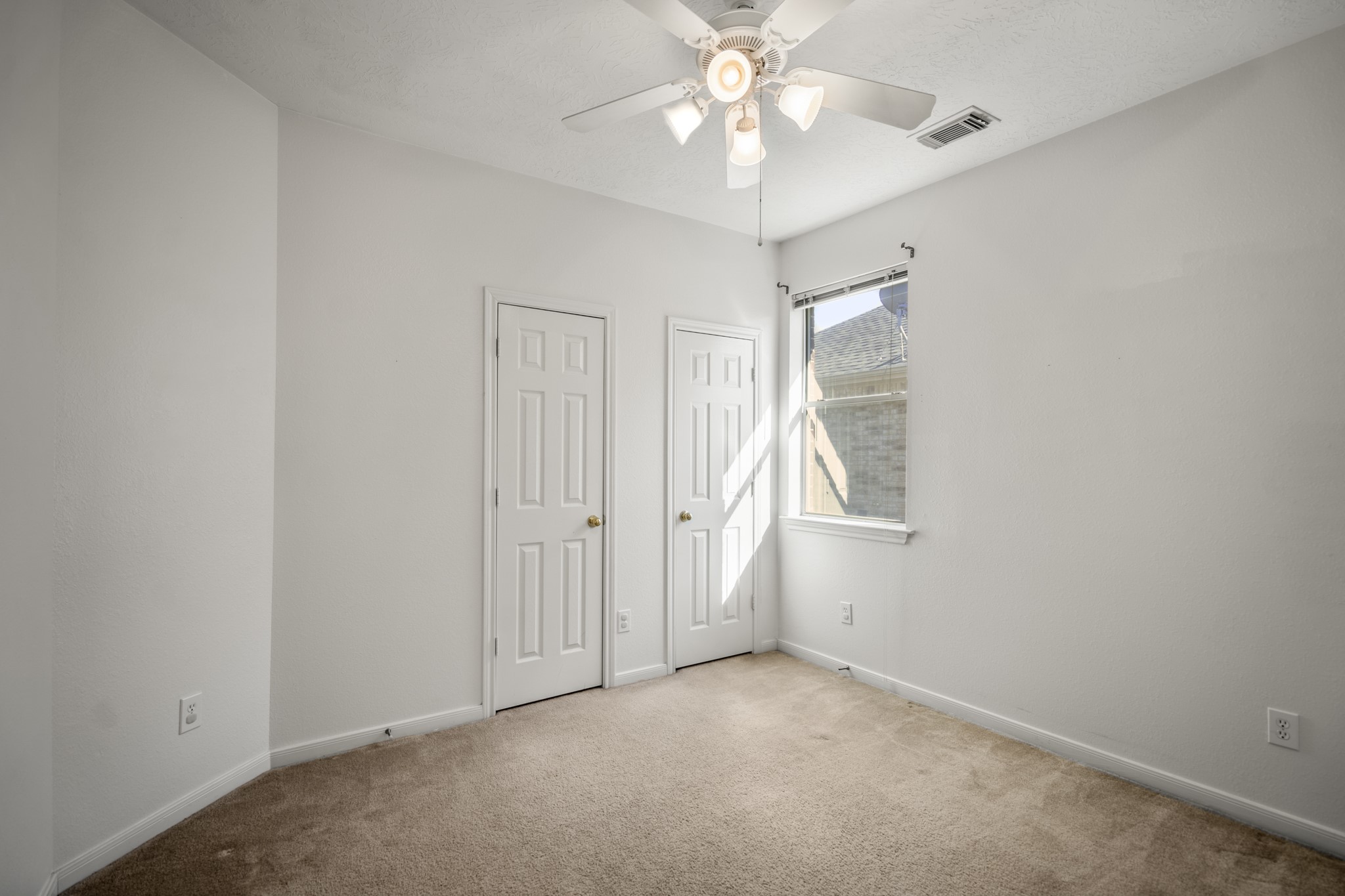 21107 Coldde Meadow Lane Spring, TX 77379 - Photo 32 of 50 The third bedroom sits along the same hallway and features a window for natural light, ceiling fan, and a closet. Both rooms share convenient access to the nearby hall bathroom.
