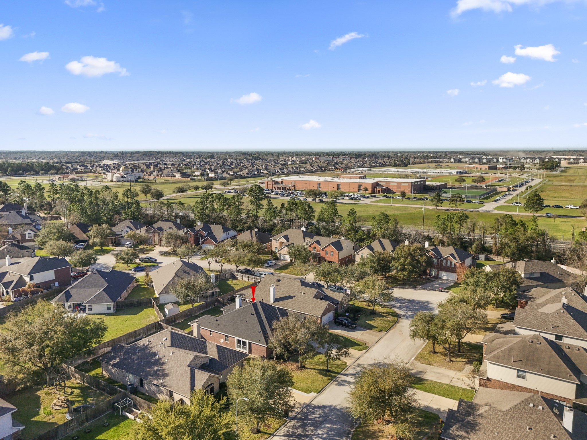 21107 Coldde Meadow Lane Spring, TX 77379 - Photo 39 of 50 A wider aerial view shows the surrounding Windrose community, known for its golf course, lakes, trails, parks, and neighborhood amenities. The location also offers convenient access to nearby shopping, dining, and major roadways including FM 2920, I-45, and Hwy 99.
