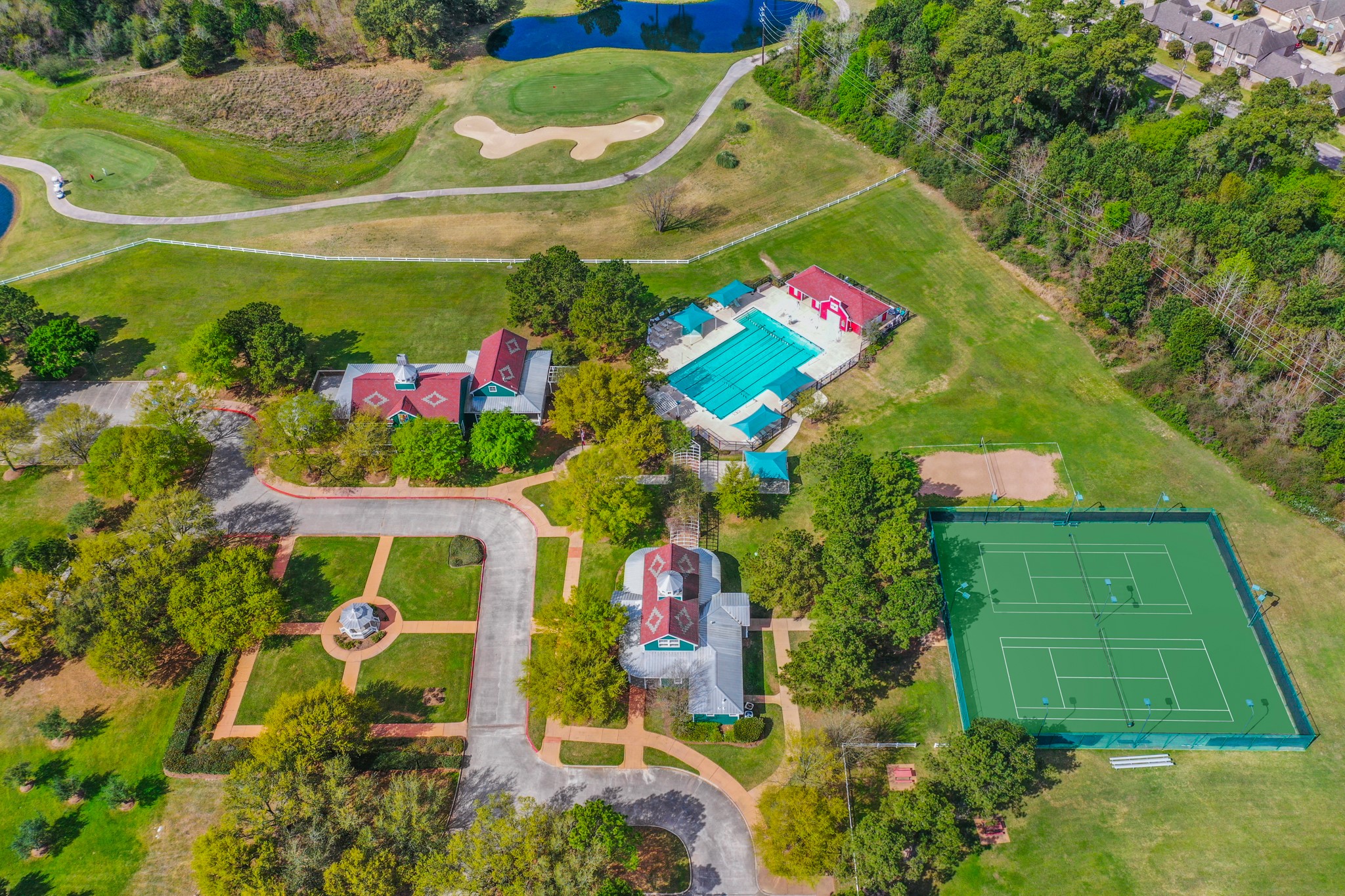 21107 Coldde Meadow Lane Spring, TX 77379 - Photo 43 of 50 This aerial view shows a picture of ONE of the two community center areas in Windrose. Here you can see our Meeting House, Club House, courtyard area, 1 of 2 of the pools in the community, &tennis courts. PLUS there is a large green space for soccer goals.