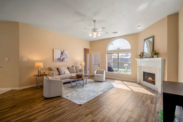 a living room with furniture and a potted plant