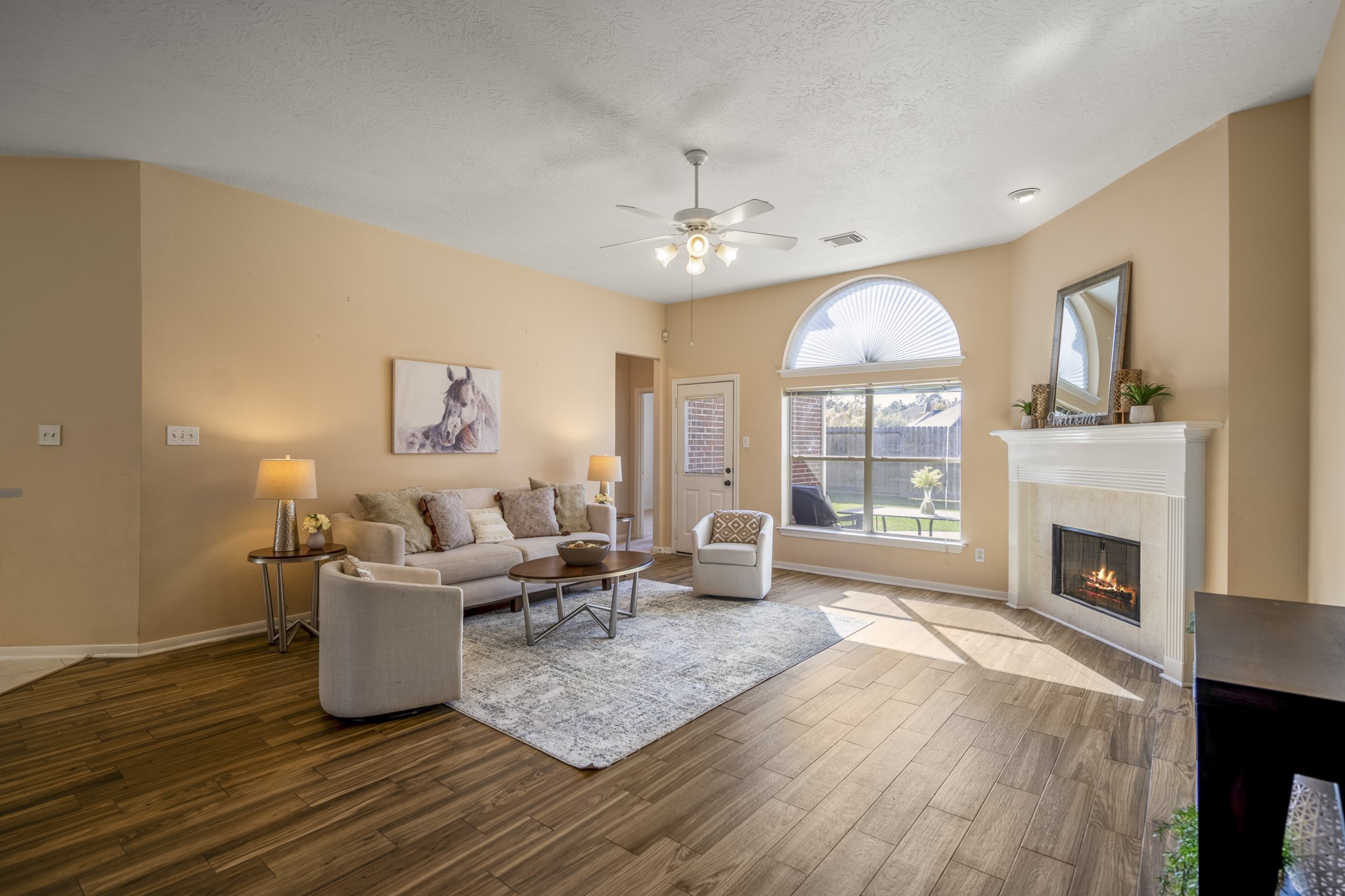 21107 Coldde Meadow Lane Spring, TX 77379 - Photo 7 of 50 a living room with furniture a fireplace and a chandelier